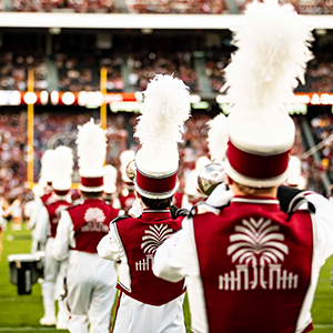 Members of the Carolina Band perform on the field at halftime of a USC football game