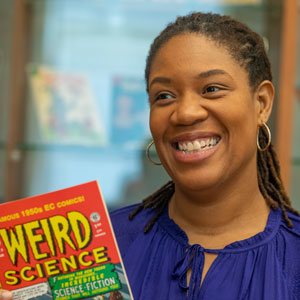Qiana Whitted holds a comic book.