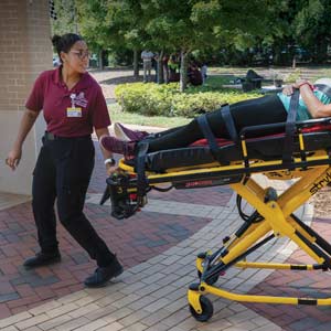 A mock victim is carried on a stretcher during a Disaster Day training session.