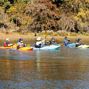 Group of kayakers on campus recreation adventure trip.