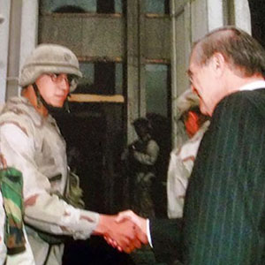 Soldier LeHeup shakes hands with then-Secretary of State Donald Rumsfeld