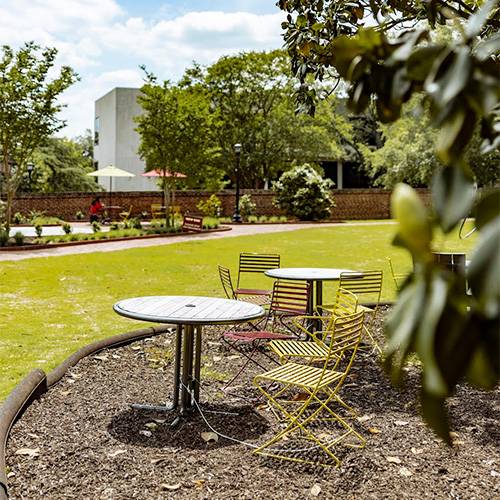 A table and chairs outside of Currell.