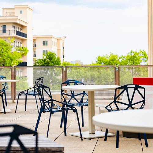 A table and chairs on the porch of the Science and Technology building.