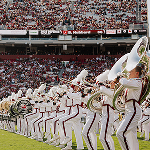 Marching band performing on a football field