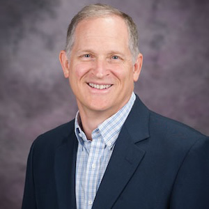 man in blue suit smiling