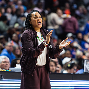 Dawn Staley coaches her team from the sidelines during a game