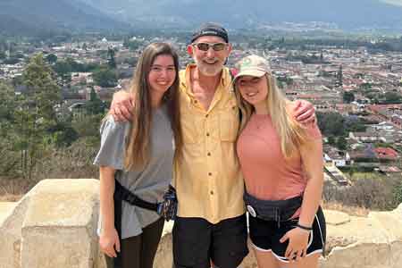 Two students pose with their professor on the Guatemala spring break program