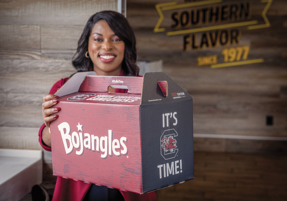 Stacey McCray holds up a Bojangles sports-themed “Big Bo” Box.