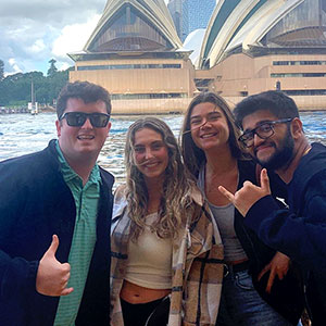 Stephen Girard Fredenberg poses with friends on the harbor in Sydney, Australia.