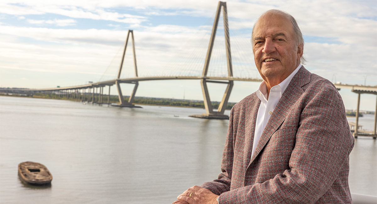 Joe Rice stands in front of a bridge on the Charleston waterfront
