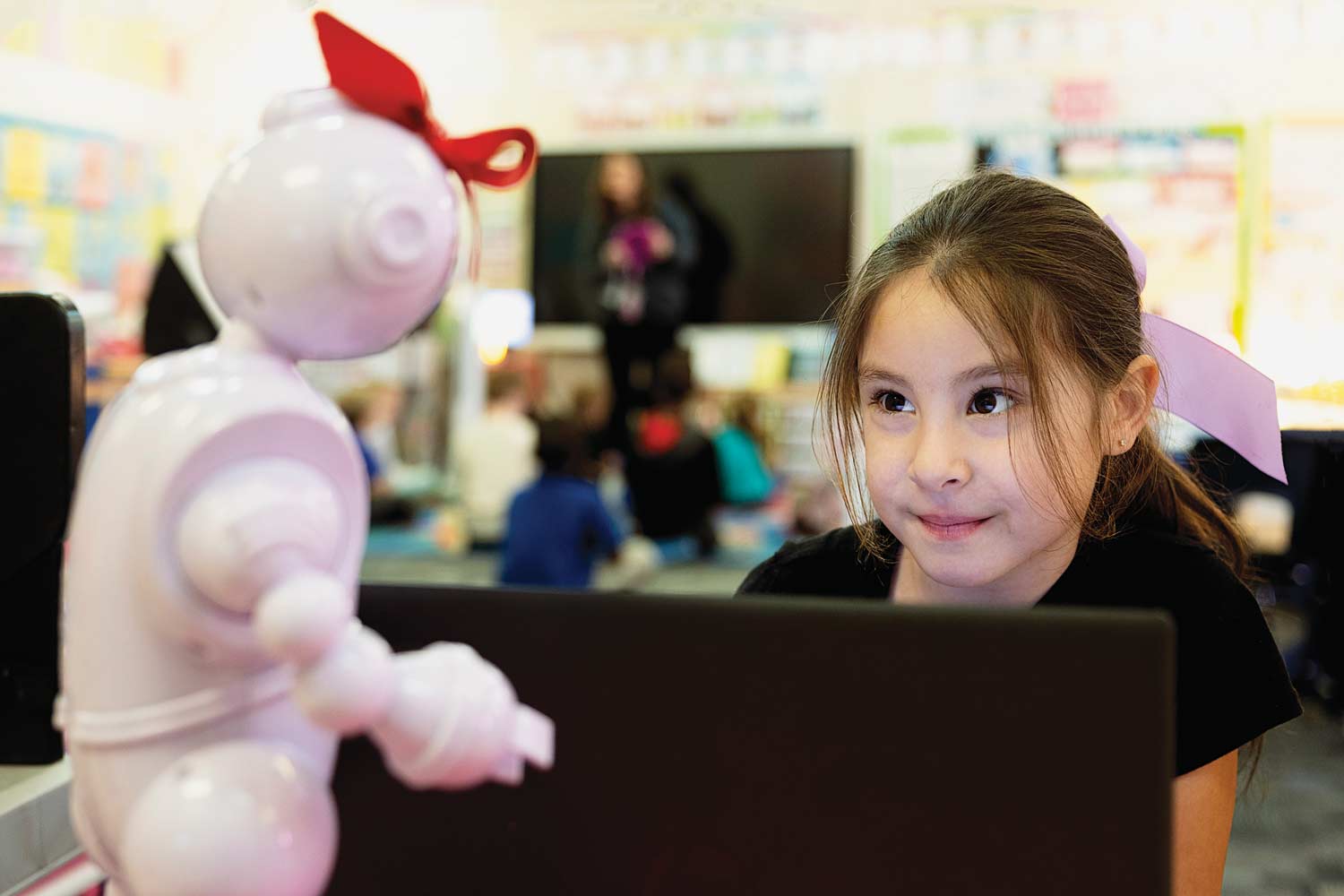 ABii robot interacts with an elementary school student.