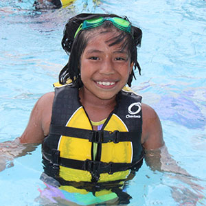 A child swims in the pool at Camp Cole