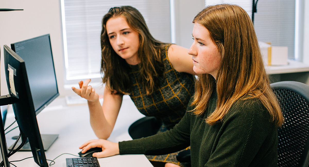 The McBride sisters working together on a computer.