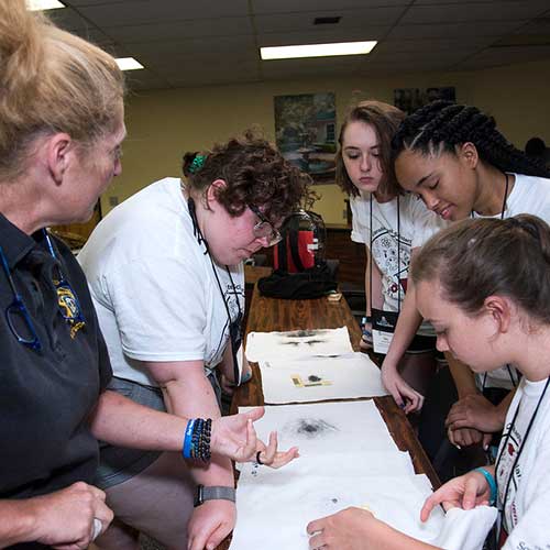 Students work in forensic science camp.