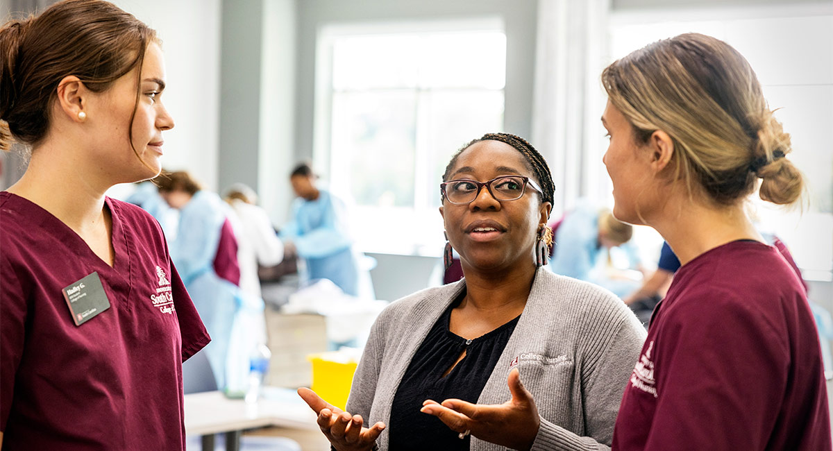 Nursing professor Joy Jackson with two USC student nurses