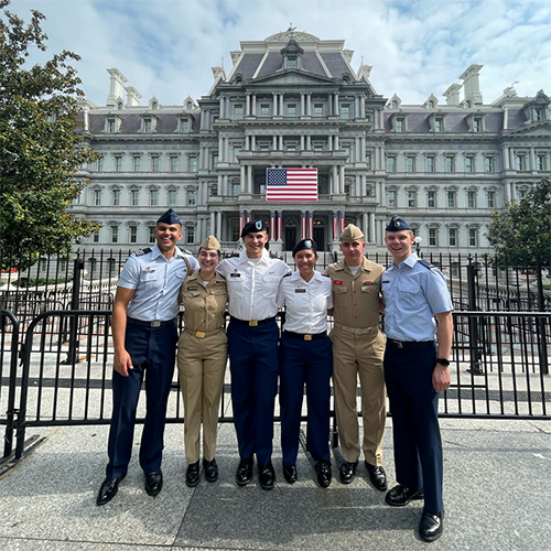 Uniformed group in front of a governmental building