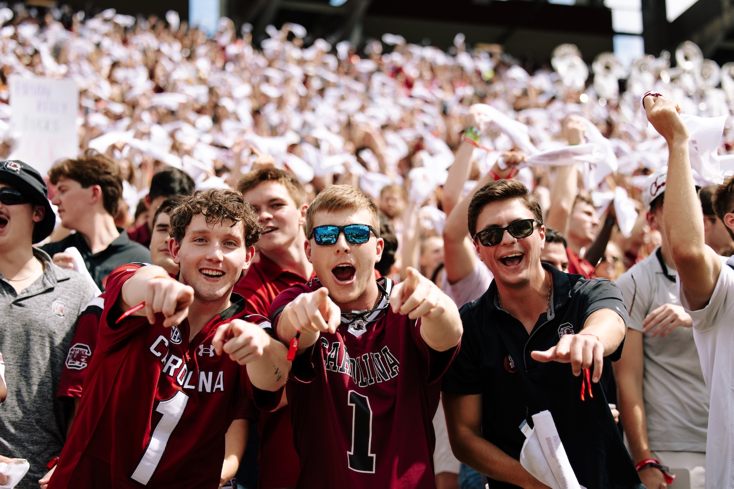 3 guys pointing at the camera and smiling at Williams Brice Stadium