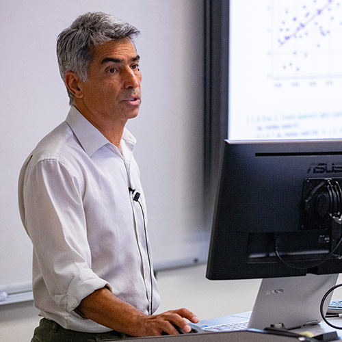 Professor stands in front of classroom 