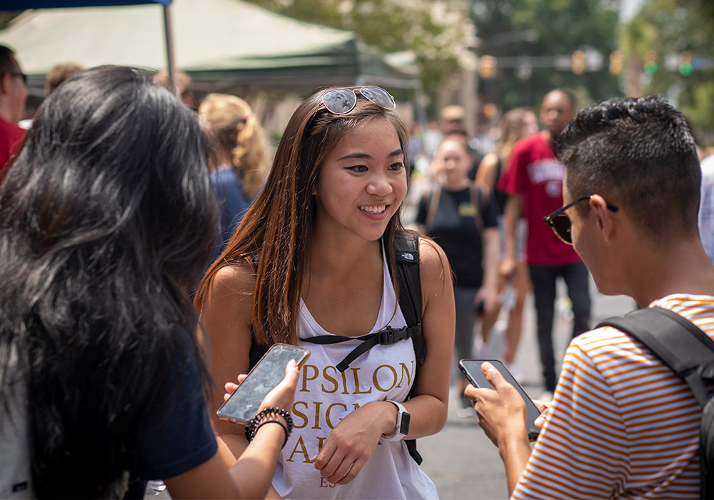 female and male student on Greene Street at org fair
