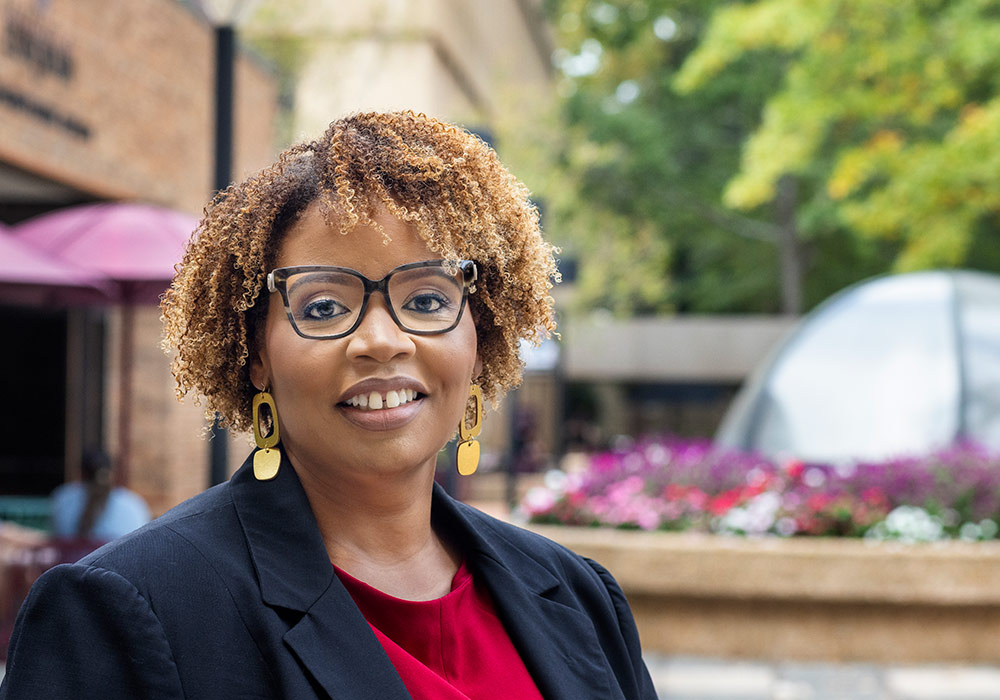 Faculty member Jewel Scott stands outside nursing building on USC campus