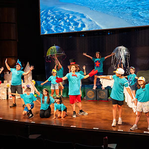 children on a stage in a theater