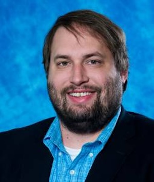 man in black suit and blue checkerboard shirt