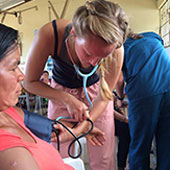 Alaina Sturkie takes a local woman's blood pressure at the Timmy Global Health clinic site.